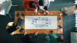 © InfiniteFlow - A diverse team collaborates around a wooden table, engaging in a strategy meeting with laptops and printed illustrations in a modern office setting. Trope