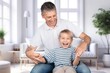 © BillionPhotos.com - Happy father or grandfather with cute child at home