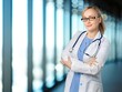 © BillionPhotos.com - Smiling nurse stands confidently at modern building background