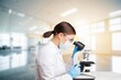 © BillionPhotos.com - Scientist  woman using microscope in modern laboratory.