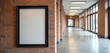 © Pete - Blank poster frame on brick wall inside modern university hall. Empty space for art, notice or advert. Wide corridor with windows and lights extends into distance.