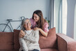 © Daniel - A young woman embraces her mature mother or grandmother at home, enjoying a quiet and loving moment together that reflects emotional connection, care, and family bonding between generations