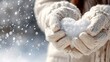 © Alunn cans - Hands holding snow shaped heart during winter season