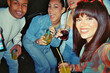 © unai - Diverse friends enjoying drinks at a retro night party