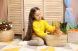© New Africa - Little girl with cute Easter bunny in wicker basket indoors