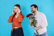 © New Africa - Embarrassed woman refusing bouquet of roses from man on light blue background