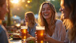 © Viktor - Friends at beer garden laugh drink beer and eat burgers. Golden hour sunset light. Young women enjoy outdoor meal, social gathering, casual meeting, outdoor dining.