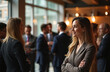 © Viktor - Smiling woman in business suit at corporate event. Professionals indoors under warm lighting. Diverse people network at elegant reception. Connections form at indoor meeting. Socializing at business