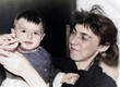 © Serge - A vintage portrait of a mother and daughter. The happy mother holds her baby in her arms. Retro photo from 1995.