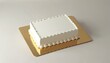 © Viktor - Blank white rectangular cake sits on gold board. White frosting borders top and sides. Perfect for adding custom text or images for events and celebrations. Copy space available.