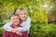 © BillionPhotos.com - Joyful old couple embracing posing in a natural setting.