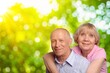 © BillionPhotos.com - Joyful old couple embracing posing in a natural setting.