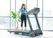 © Bangkok Click Studio - Asian young beautiful cheerful happy woman active fit sport girl in sportswear using calling mobile smartphone exercise running jogging on treadmill training in fitness gym, healthy wellness lifestyle