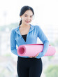 © Bangkok Click Studio - Asian young beautiful happy smiling cheerful woman active sport in sportswear standing holding yoga mat prepare exercise pilates stretching training in bright fitness gym healthy wellness lifestyle.