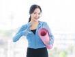 © Bangkok Click Studio - Asian young beautiful happy smiling cheerful woman active sport in sportswear standing holding yoga mat prepare exercise pilates stretching training in bright fitness gym healthy wellness lifestyle.