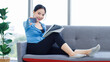 © Bangkok Click Studio - Asian young beautiful happy woman sporty active healthy in sportswear sitting cozy sofa using digital tablet and credit card exercise training in bright in living room fitness gym wellness lifestyle.