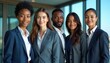 © Maryna - Diverse group of five young professionals stand together, dressed in business attire. Smiling, representing modern, inclusive workplace, teamwork. Team embodies collaboration, future success.