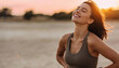 © THESUN - Happy healthy beautiful woman smiling outdoor during sunset. Closeup portrait of active young adult enjoying serene moment in nature