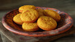 © Thiago - Delicious cornbread muffins arranged in an attractive bowl on a wooden table, perfect for culinary endeavors