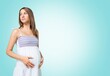 © BillionPhotos.com - Happy young Pregnant Woman Standing Over Studio Background.