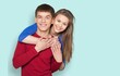 © BillionPhotos.com - Happy Young Couple Hugging Posing at Studio Backdrop,