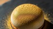 © Ariestia - Opulent dessert creation dusted with shimmering edible gold particles rests on a dark surface