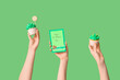 © Pixel-Shot - Female hands with tasty cupcakes and festive postcard for St. Patrick's Day on green background