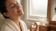 © Worldwide - Closeup of a beautiful woman applying perfume