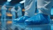 © forenna - A laboratory scene emphasizes research with scientists donning disposable blue shoe covers, showcasing the critical role of cleanliness in experiments and technology applications. cinematic color