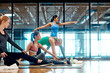 © BuyoutReese07/peopleimages.com - Women, stretching and yoga class with group for exercise or pilates together in gym. Female people, team or friends with body warm up or balance for fitness or physical activity in health club