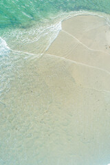  Aerial top view of turquoise ocean waves on white sand beach The Concept of Serenity