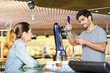 © auremar - barman serving beer for young female customer