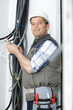 © auremar - tradesman with reel of cable on shoulder giving thumbs up