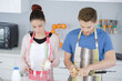 © auremar - young couple cooking in the kitchen