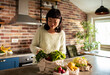 © Davor - Woman unpacking fresh vegetables in home kitchen