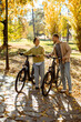 © BGStock72 - Couple enjoys a sunny autumn day while riding electric bikes in a peaceful park