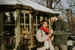 © BGStock72 - Korean woman and Caucasian man enjoy warm drinks outside on a snowy day