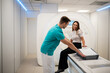 © Zoran Jesic - Radiologist assisting woman preparing for mri scan