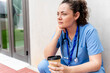 © StockMe - Medical professional taking a contemplative coffee break outdoors, experiencing burnout and stress while working in healthcare. Copy space