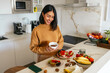 © Alberto - Woman enjoying coffee and healthy breakfast in kitchen