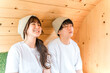 © buritora - A young couple wearing T-shirts in a sauna