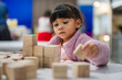 © geargodz - preschool child girl concentrating on building tower with wooden block