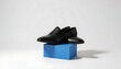 © BeeSee - Black men Shoes Displayed on Blue Stand, Elegant Pair of black  Leather Loafers on Minimal Display Stand, created with generative ai
