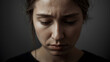 © siraphol - Sad young woman portrait with furrowed brow and downcast gaze expressing isolation