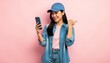 © ChimE - Joyful Interaction: A young person, holding a smartphone and pointing with a gesture on the soft pink background, the interaction conveys a sense of happiness, connectivity, and playful engagement.