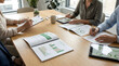 © abdul studio - Business Meeting Reviewing Sustainability Report and Charts