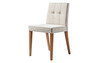 © Sarring - A light beige upholstered chair with wooden legs against a stark black background