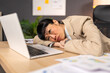 © Graphicroyalty - Burnout and exhaustion at work. Asian businesswoman lying on office desk feeling tired and overwhelmed. Career failure, mental health, and professional stress concept in corporate workspace.