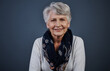 © JamPacked/peopleimages.com - Smile, relax and portrait of old woman in studio for confidence, retirement and pride. Happiness, elderly pensioner and calm with senior person on dark background for wellness, chill and space