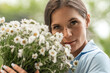 © svetograph - Daisies woman portrait: Smiling lady holds white bouquet outdoors, enjoying nature, summertime.
